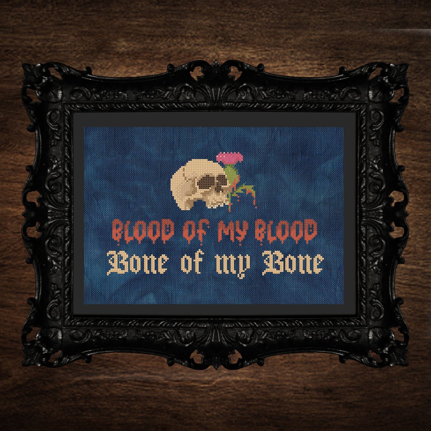 Skull with a bleeding thistle above stylized text of Blood of my Blood, Bone of my Bone.